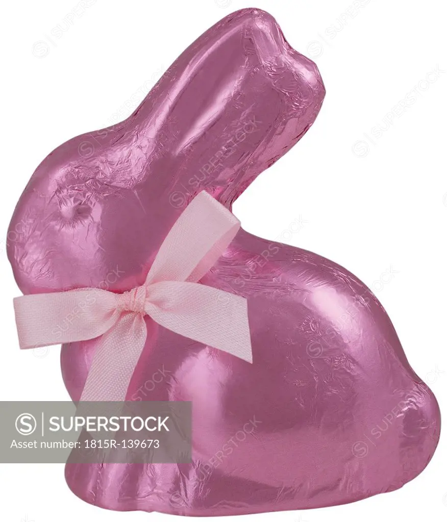 Pink chocolate easter bunny on white background, close up