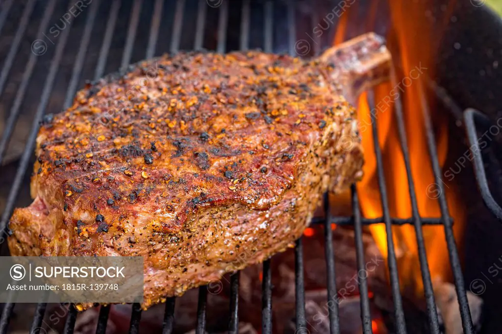 Beef bone grilling on charcoal, close up