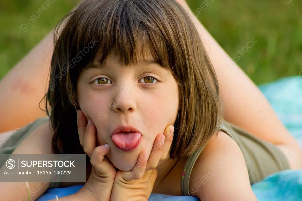 Germany, Baden Wuerttemberg, Portrait of girl sticking out tounge