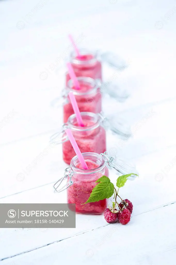 Raspberry smoothie on table, close up