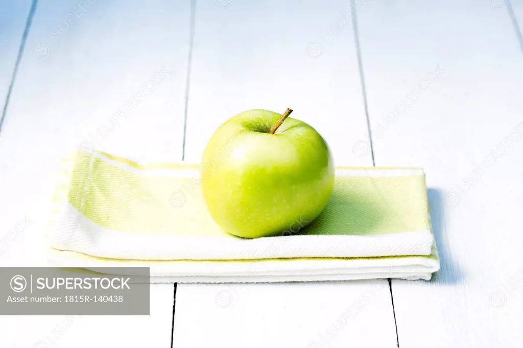 Green apple on napkin, close up