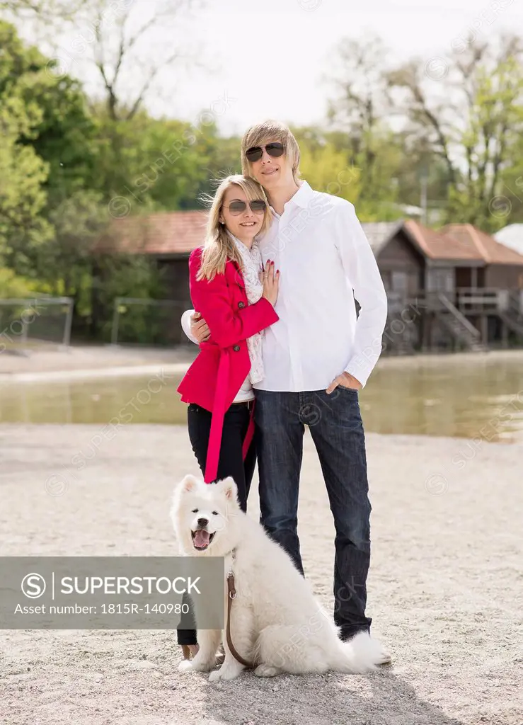 Germany, Bavaria, Portrait of couple standing with dog