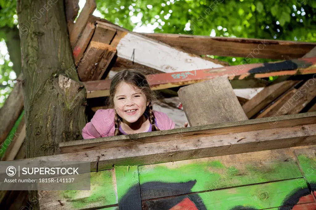 Germany, North Rhine Westphalia, Cologne, Girl playing in playground, smiling