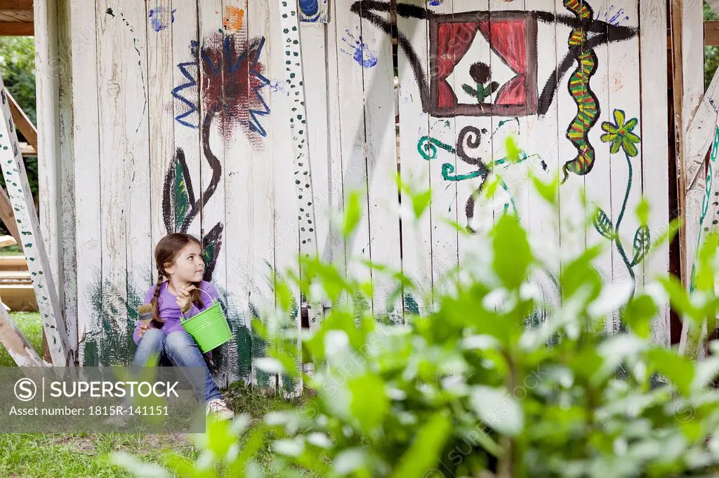 Germany, North Rhine Westphalia, Cologne, Girl sitting in playground