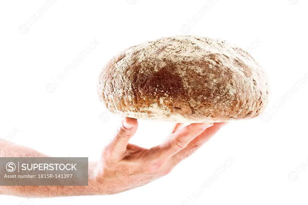 Mature man holding bread, close up