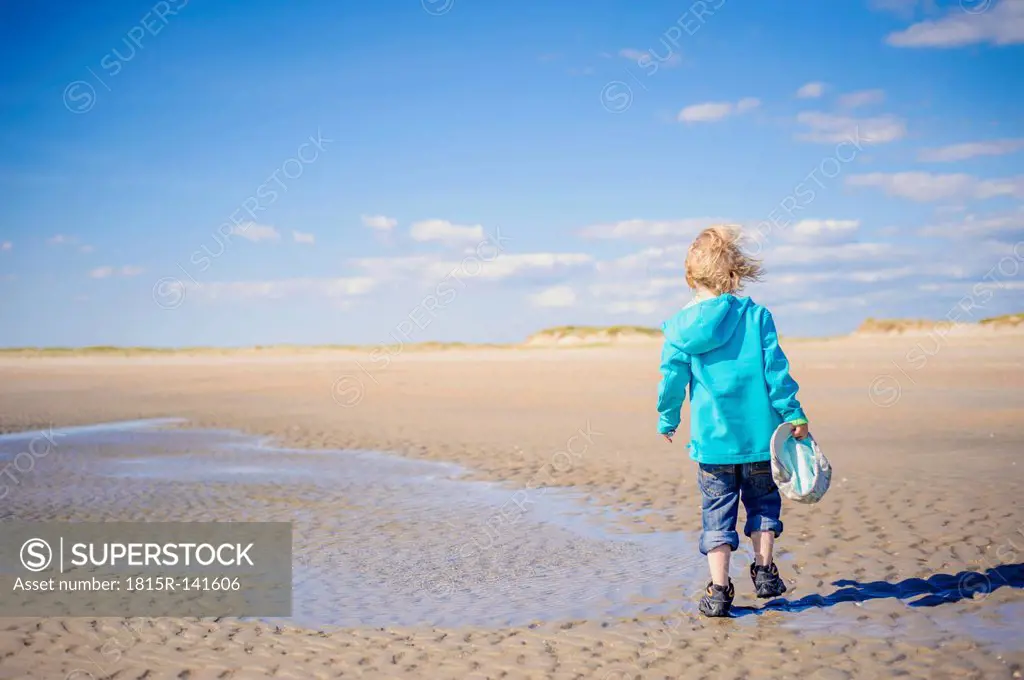Denmark, Romo, Boy walking at North Sea