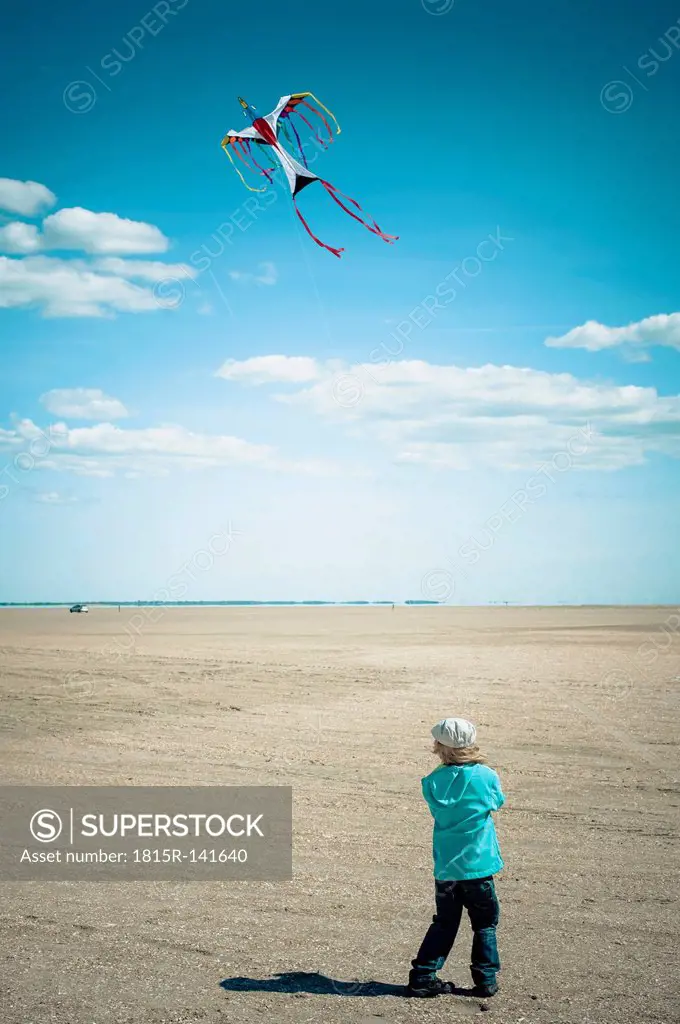 Denmark, Romo, Boy flying kite at North Sea