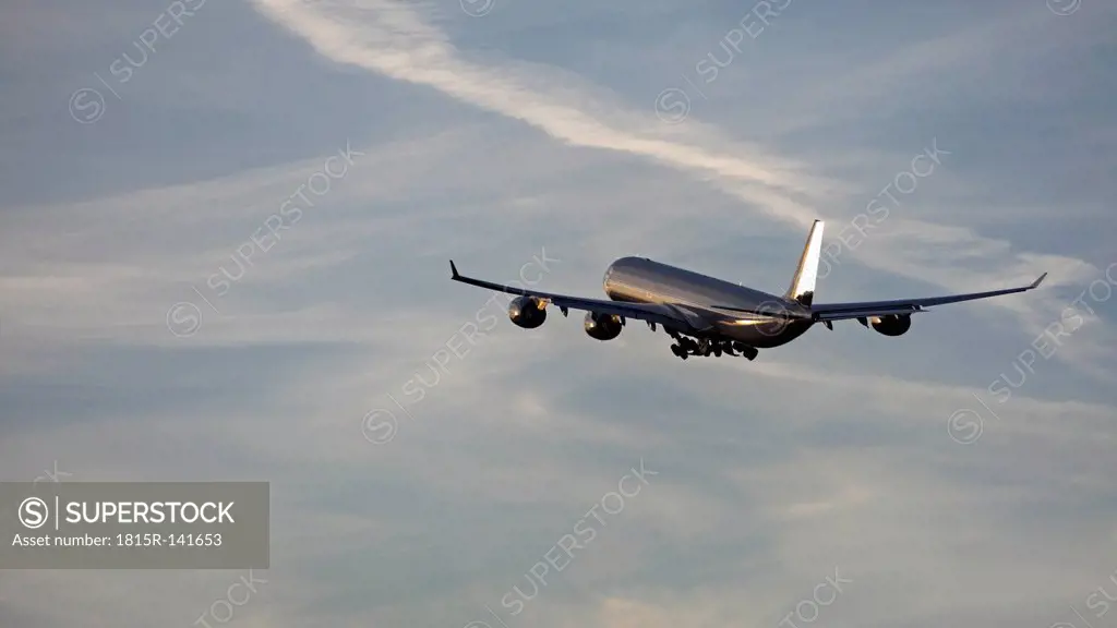 Germany, Bavaria, Munich, View of airbus a 340-600 departing at sunset