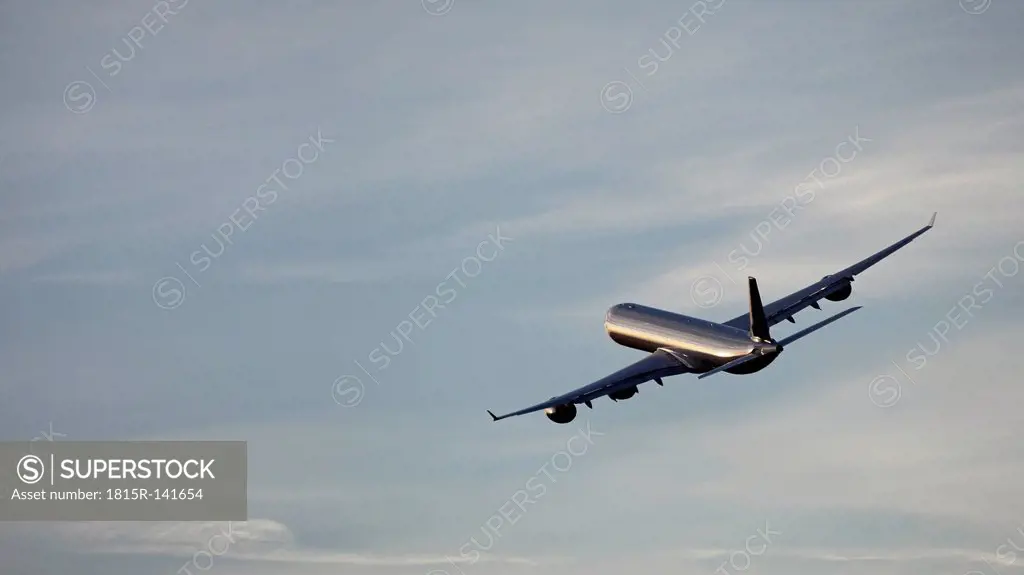 Germany, Bavaria, Munich, View of airbus a 340-600 departing at sunset