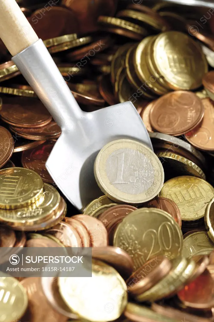 Shovel in Euro coins, (symbol for accumulating money), close-up