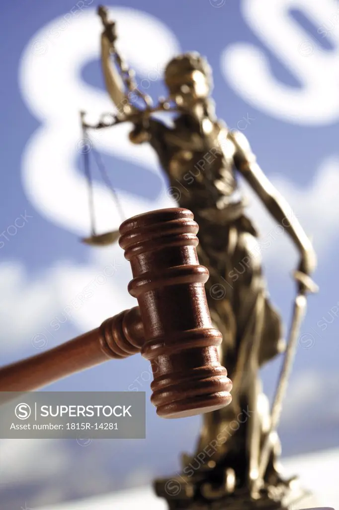 Gavel with statue of justice, close-up