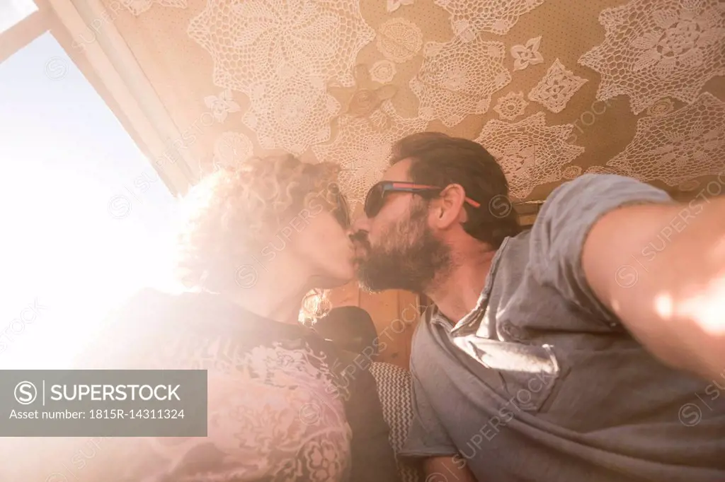 Couple kissing in backlight