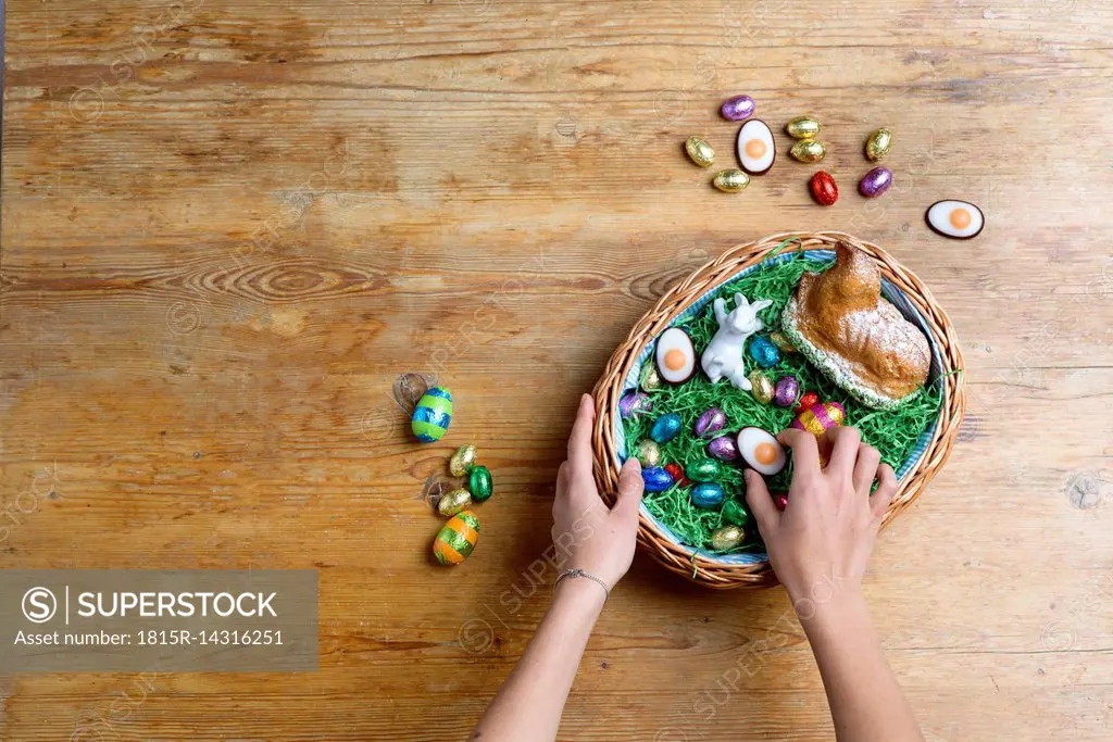 Hands filling Easter nest