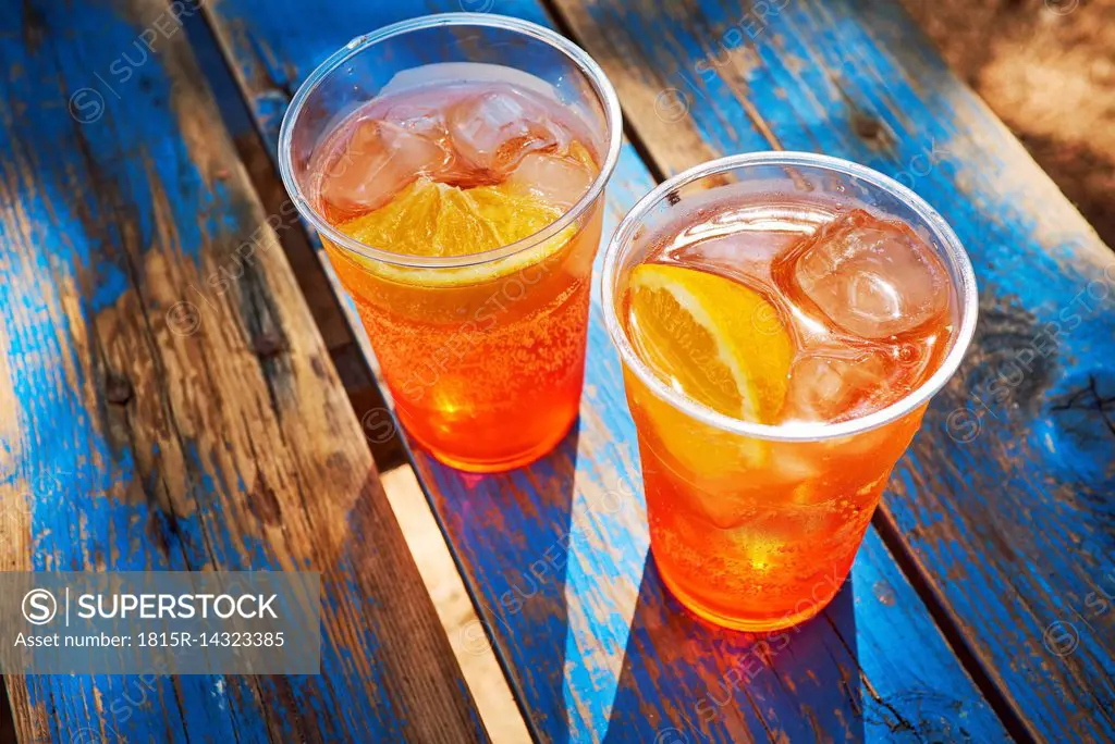 Two cups of ice-cooled Spritz with orange slice