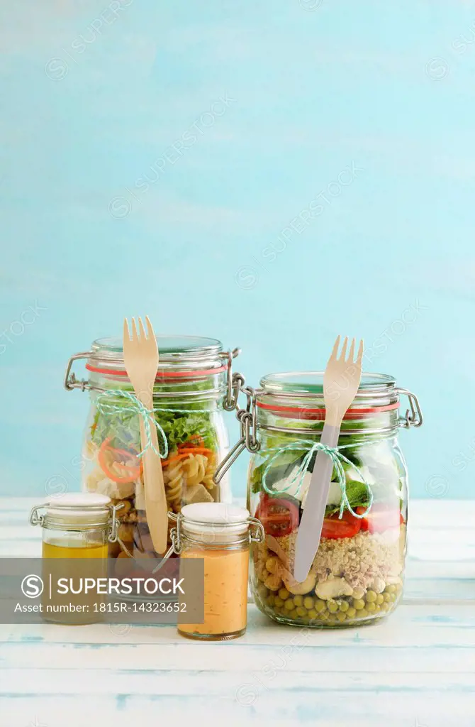 Preserving jars of various mixed salad and jars of salad dressings