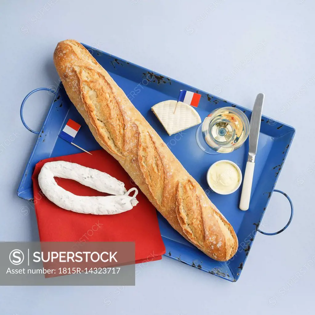 French snack with baguette , white wine, camembert and salami