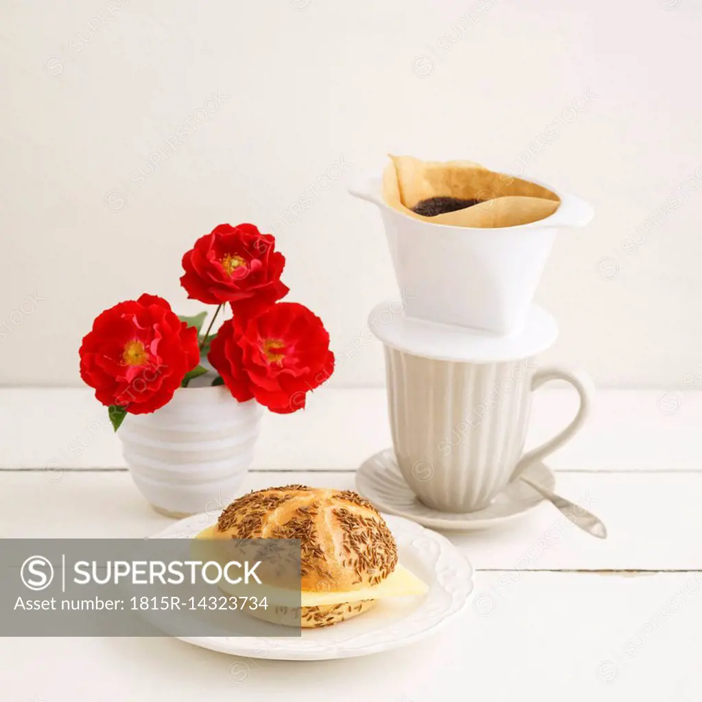 Bread roll with cheese and pour over coffee