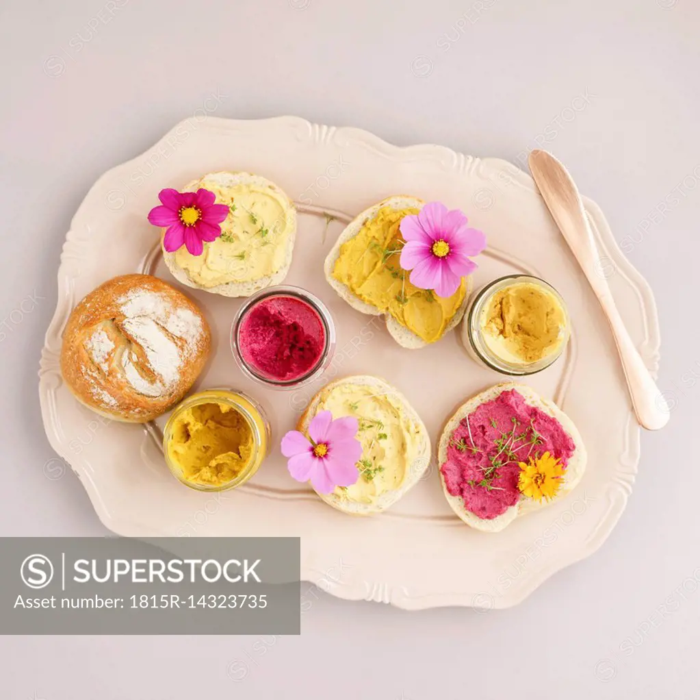 Bread rolls with vegan spreads and edible flowers