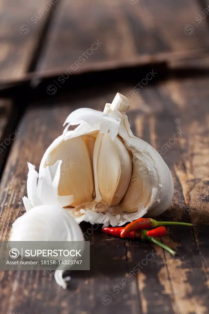 Garlic and chili pepper on dark wood