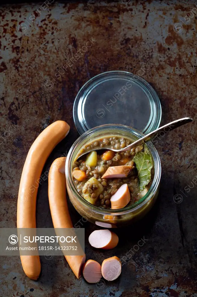 Preserving jar with lentil soup and sausages