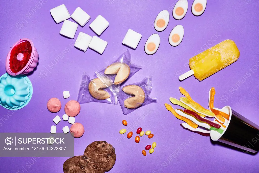 Different sorts of sweets on purple background