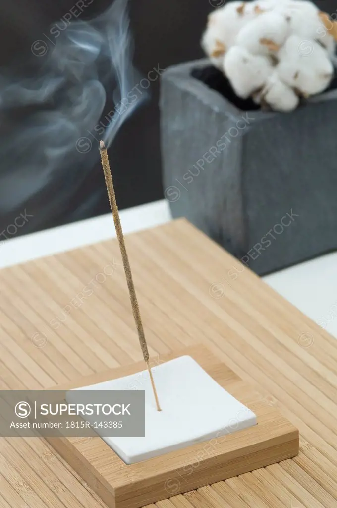 Aroma stick with cotton boll in background, close up