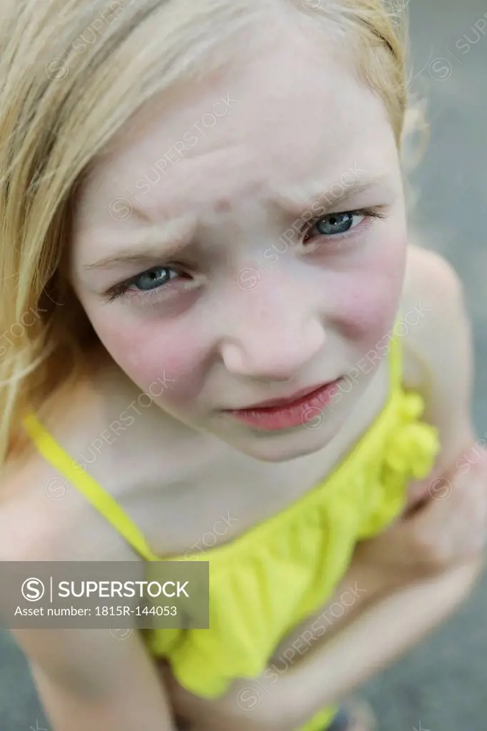 Germany, North Rhine Westphalia, Cologne, Portrait of girl standing on street, close up