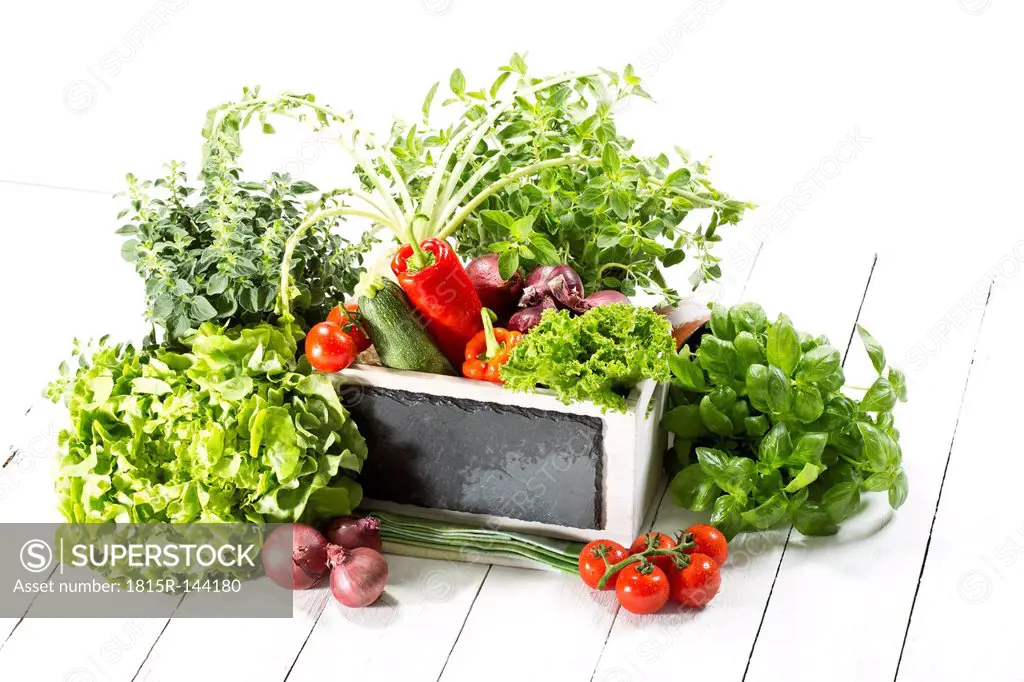 Variety of fresh vegetables in wooden box, close up