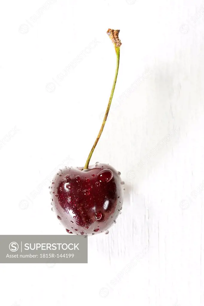 Cherry on wooden table, close up