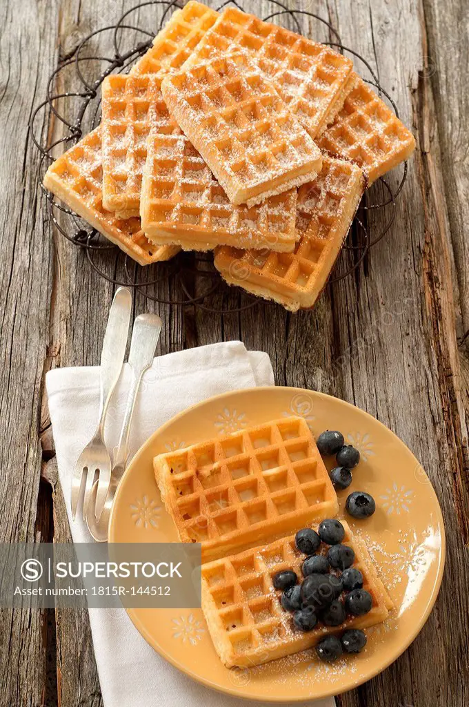 Waffles with blueberries in plate, close up