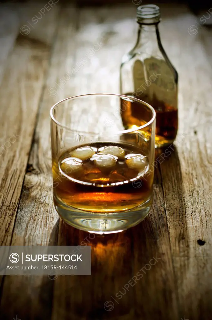 Brandy with ice cubes and bottles
