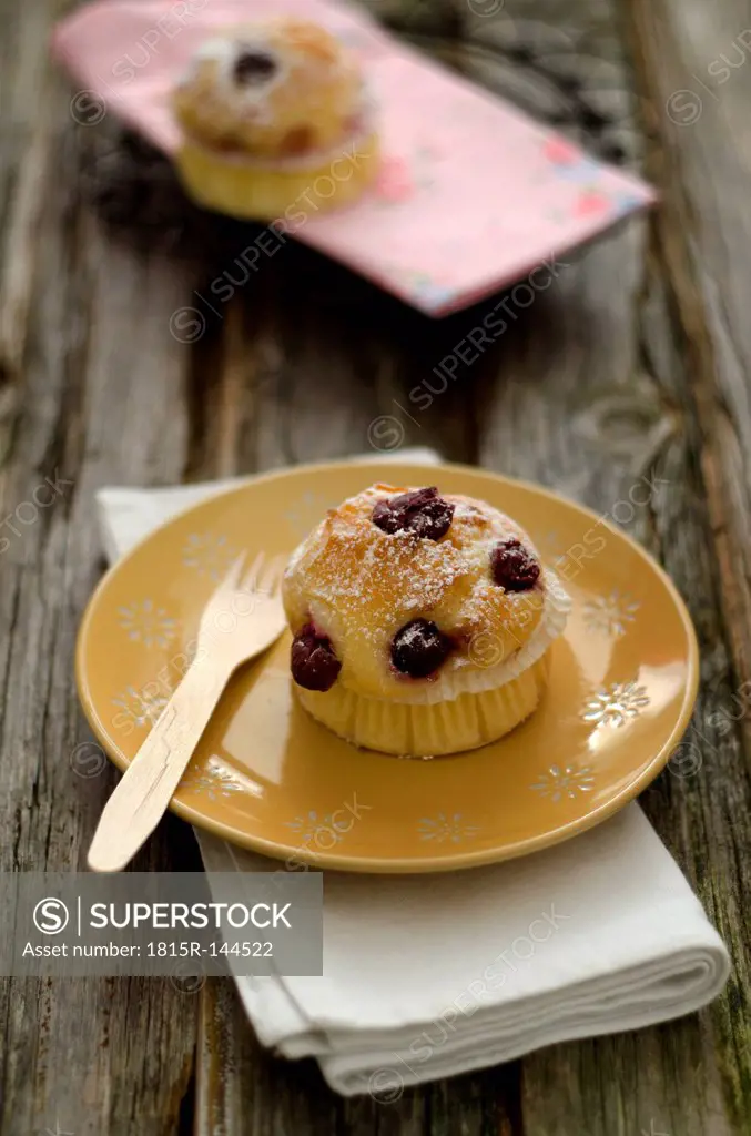 Cupcakes with cherries on plate, close up