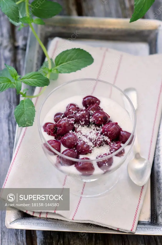Rice pudding with cherries in tray on table