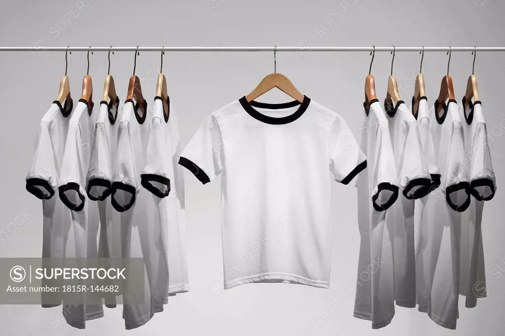 Football shirts on clothes hangers, studio shot