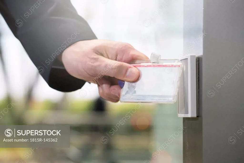 Germany, Hannover, Businessman using access card, close up