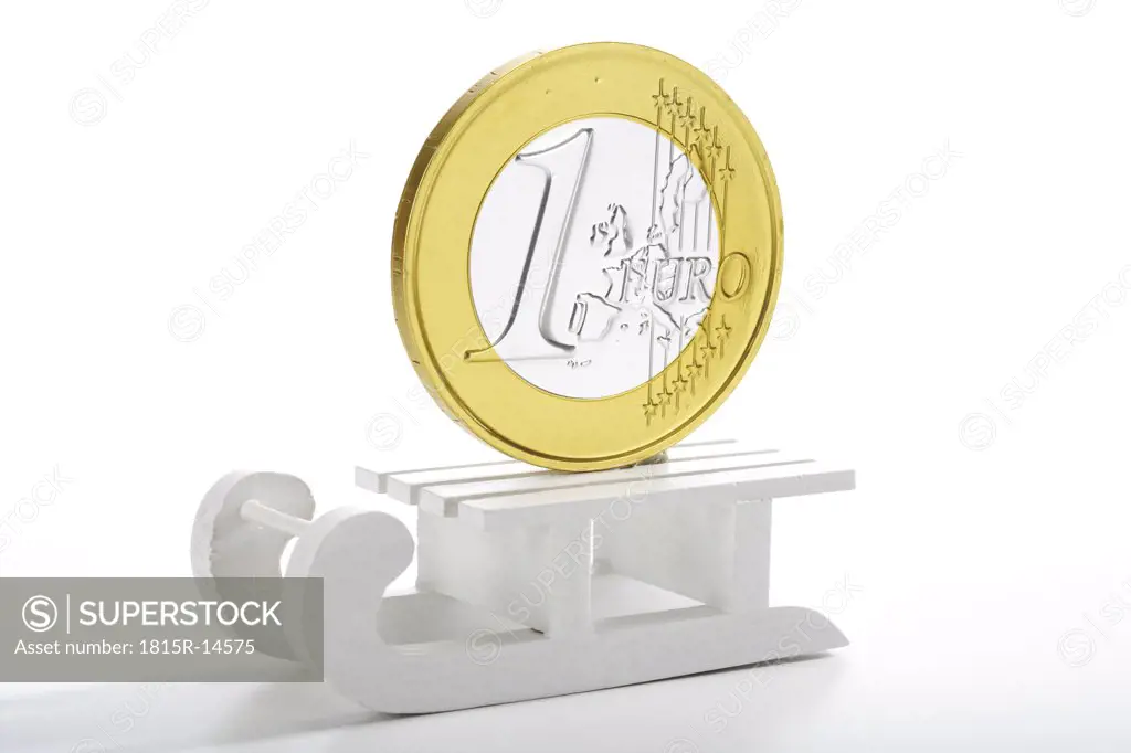 Euro coin on toy sledge