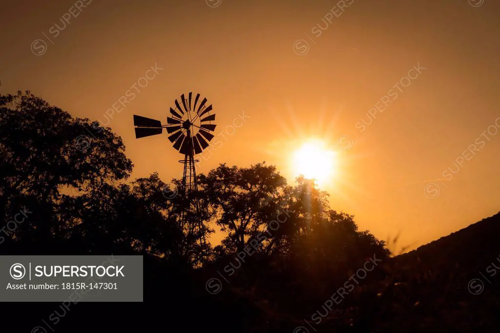 USA, Texas, silhouette of irrigation windmill on a farm at sunset