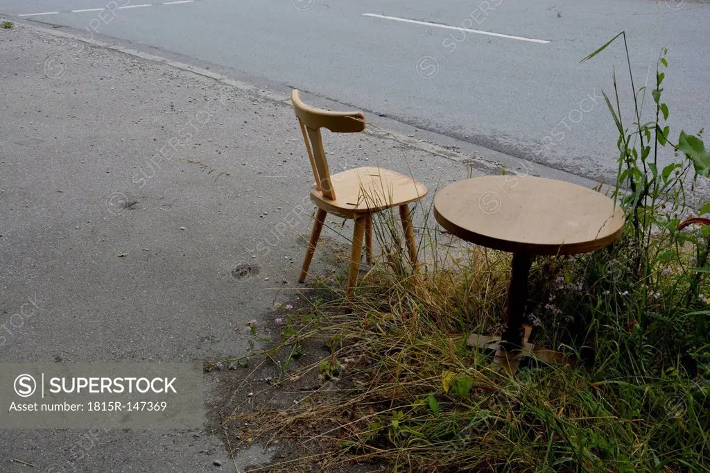 Germany, Bavaria, Riem, wooden chair and table at the roadside