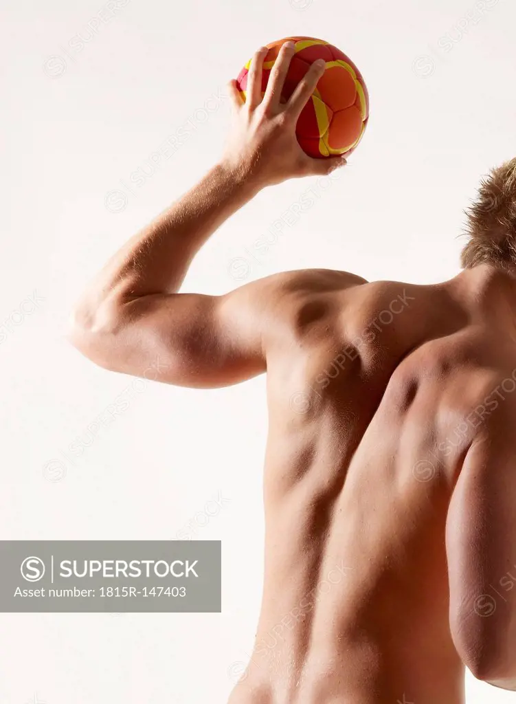 Studio, sporty naked handballer during shot
