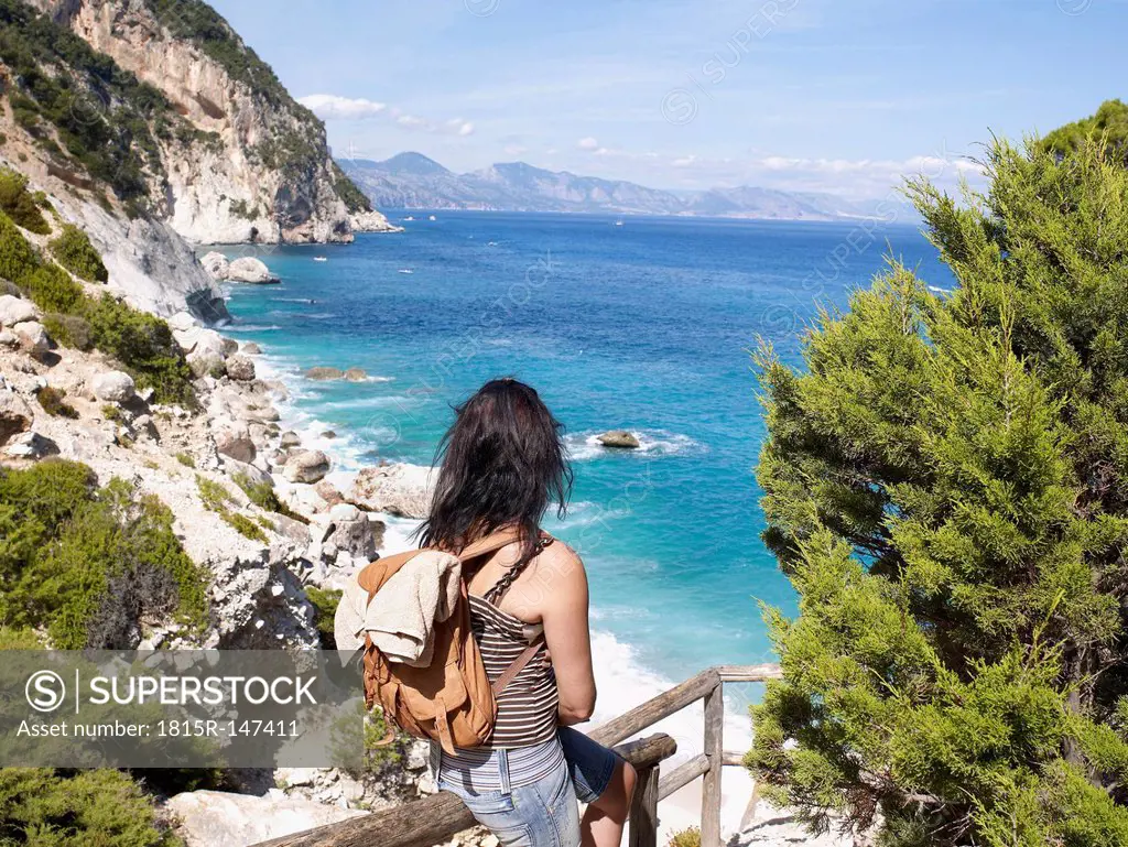 Italy, Sardinia, Gulf of Orosei, Hiker looking at view