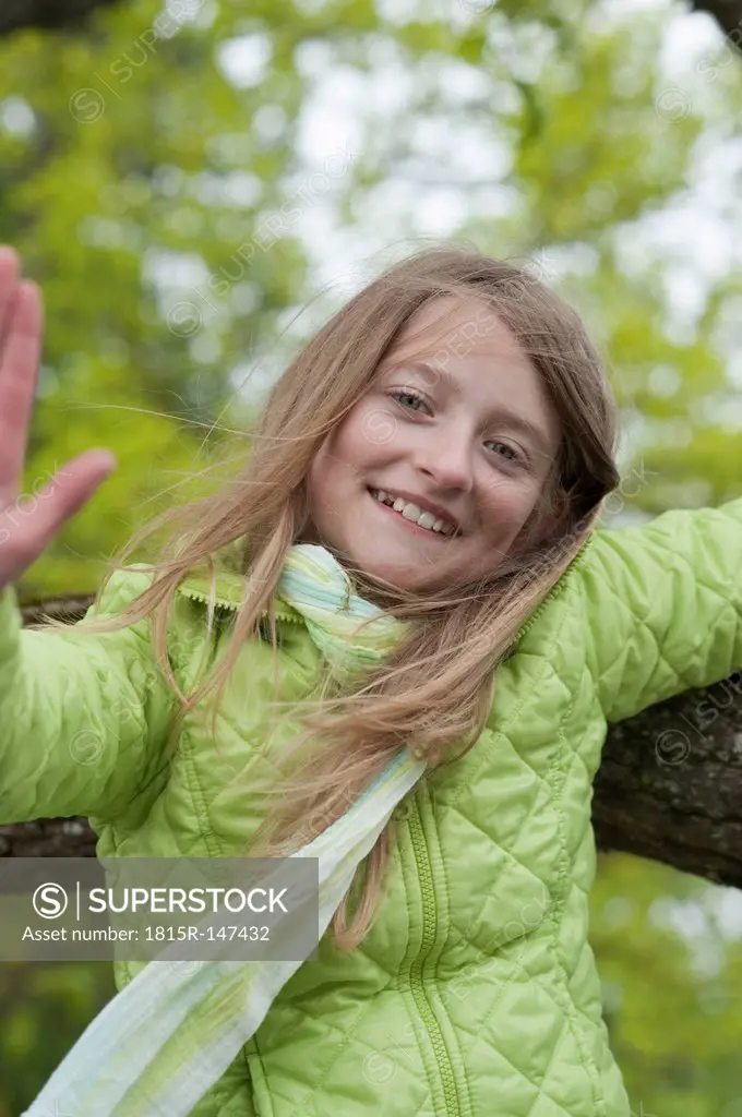 Germany, Bavaria, girl climbing on an oak