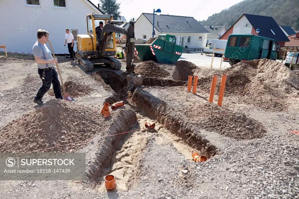 Germany, Rhineland-Palatinate, house building, earth works, laying pipes