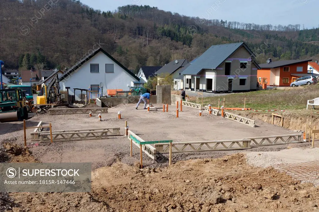 Germany, Rhineland-Palatinate, house building, earth works, laying pipes before pouring the concrete of foundation