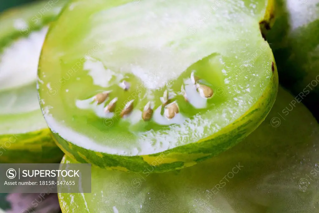 Detail of sliced green zebra tomatoes (Solanum lycopersicum), studio shot