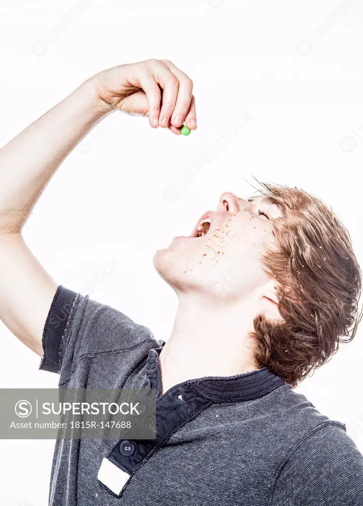Teenage boy eating a bonbon