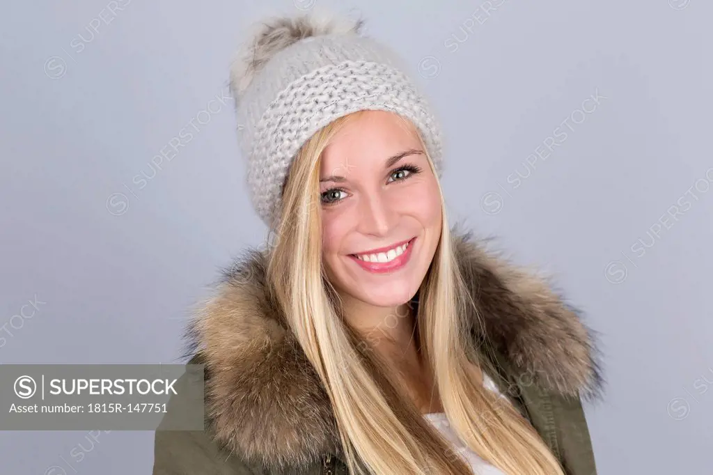 Portrait of young woman with bobble hat