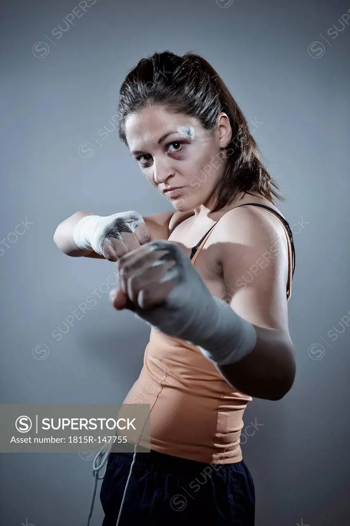 Portrait of a young female boxer in defending position