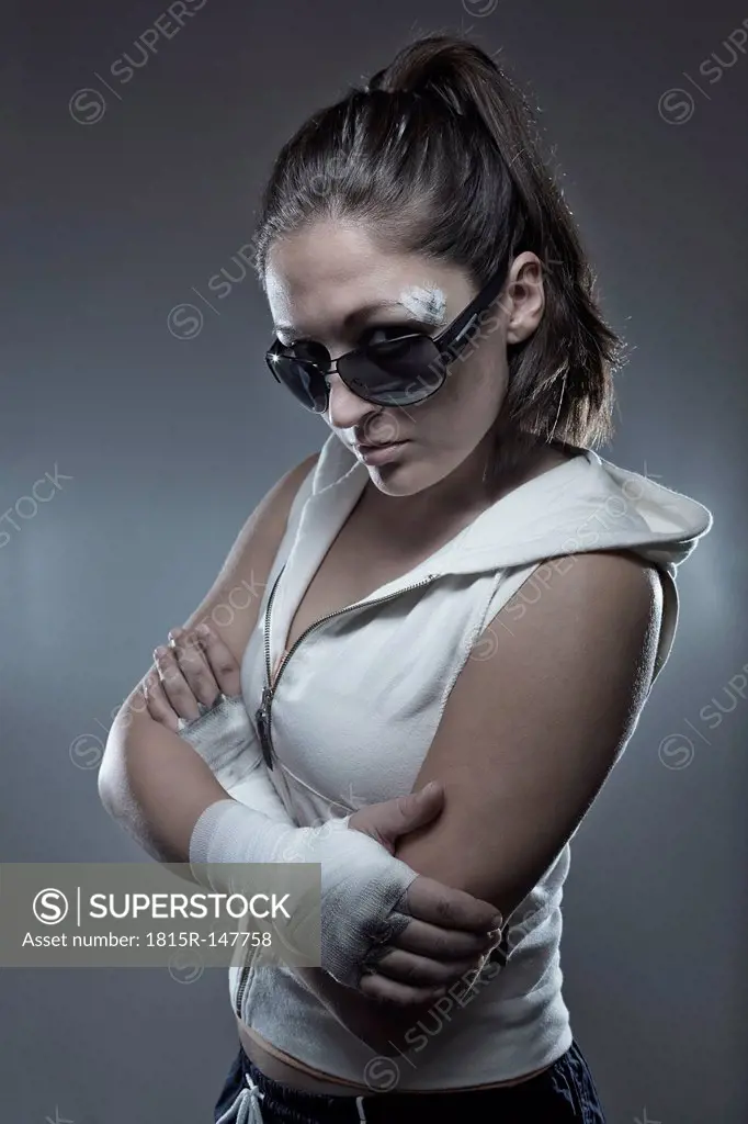 Portrait of a young female boxer with folded arms