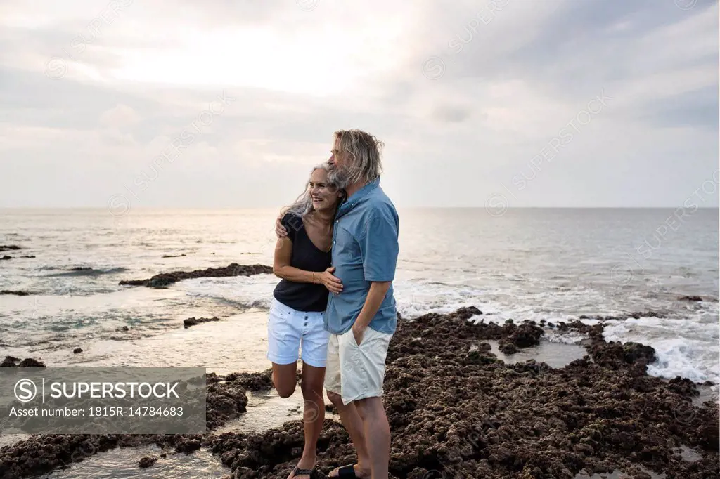 Affectionate senior couple embracing at the sea