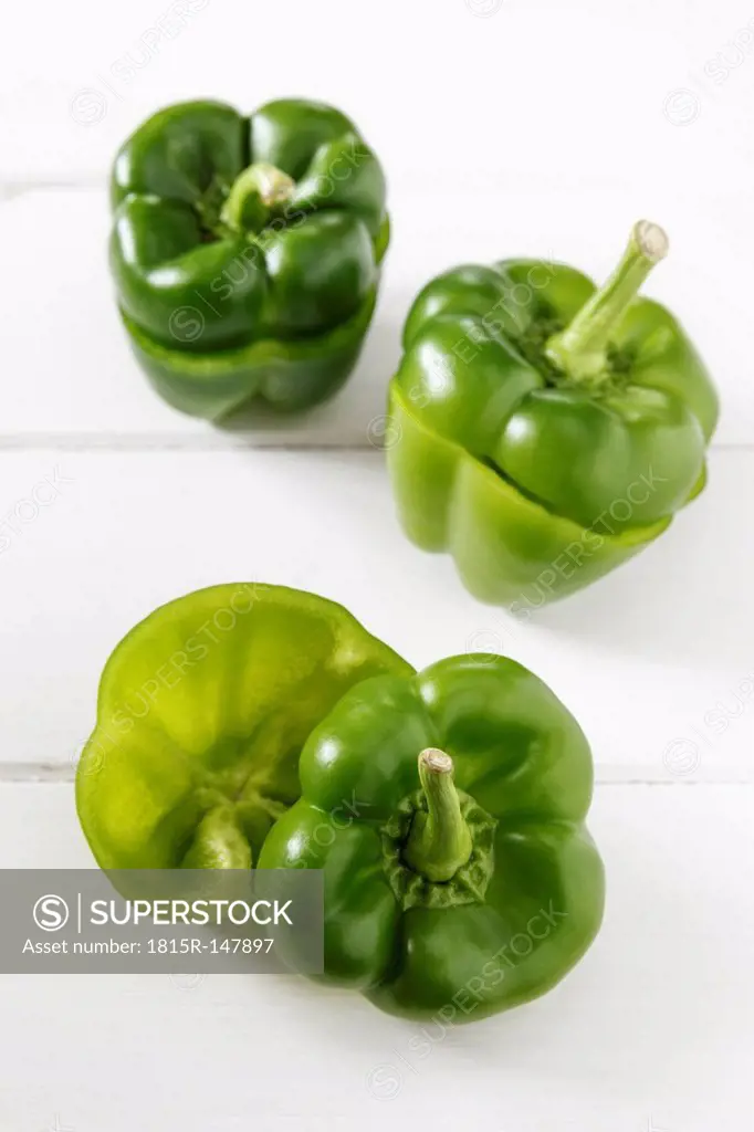 Three sliced green bell peppers, studio shot